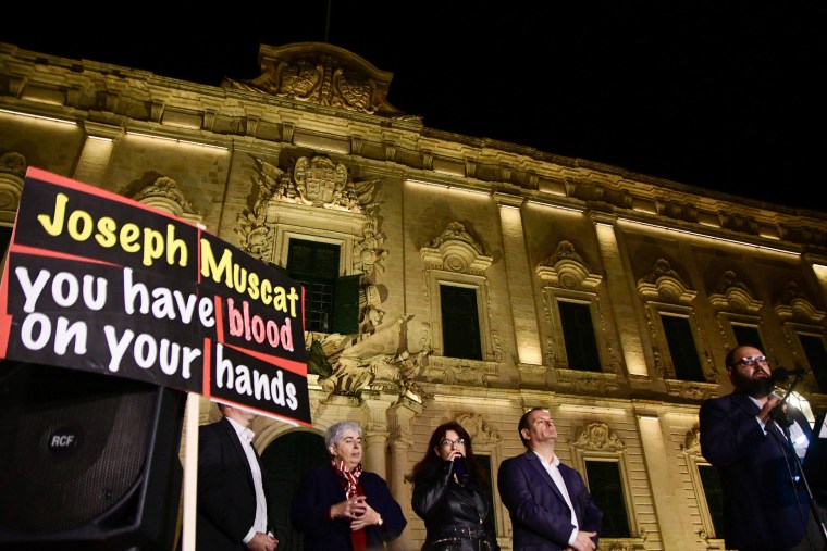 Image: Blogger Manuel Delia (R) addresses the crowd of protesters gathered outside the Prime minister's office in Valletta