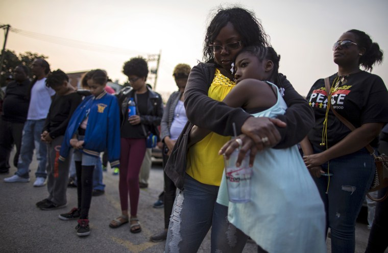 People gather for a candlelight vigil against gun violence in the Englewood neighborhood in Chicago