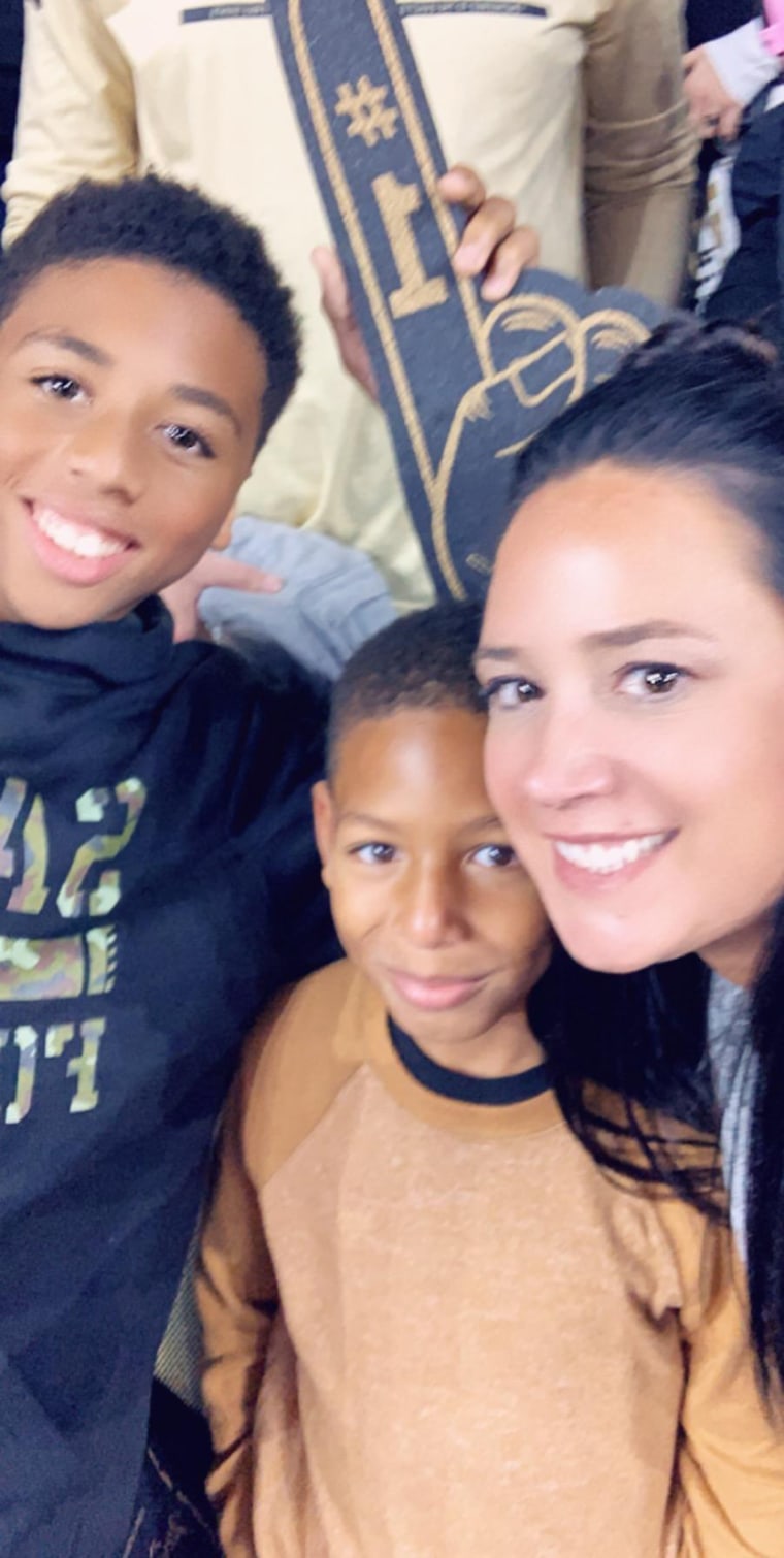 Danielle Ayo Trahan quickly formed a bond with brothers Terrion Shaffer, 14, and Jairen Fisher, 8, sitting next to her and her husband Dustin at a recent New Orleans Saints football game. 