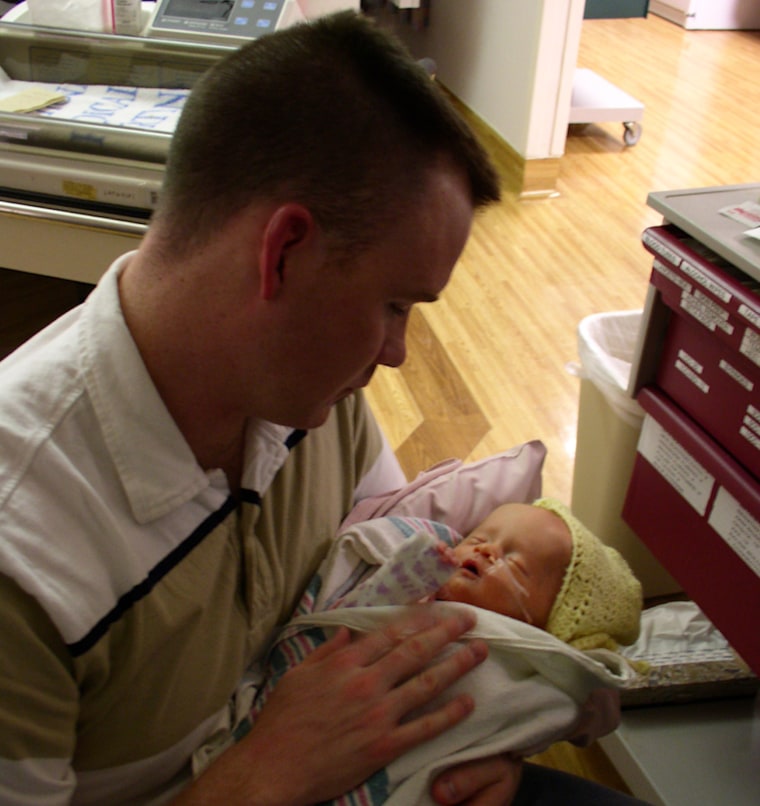 Jeremy Hilton holds his baby daughter, Kate, in 2002.