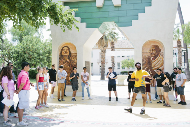 Malachi Taylor, 21, leads a campus tour for prospective students and their families at San Jose State University, part of a public university system that is working to improve its graduation rates.