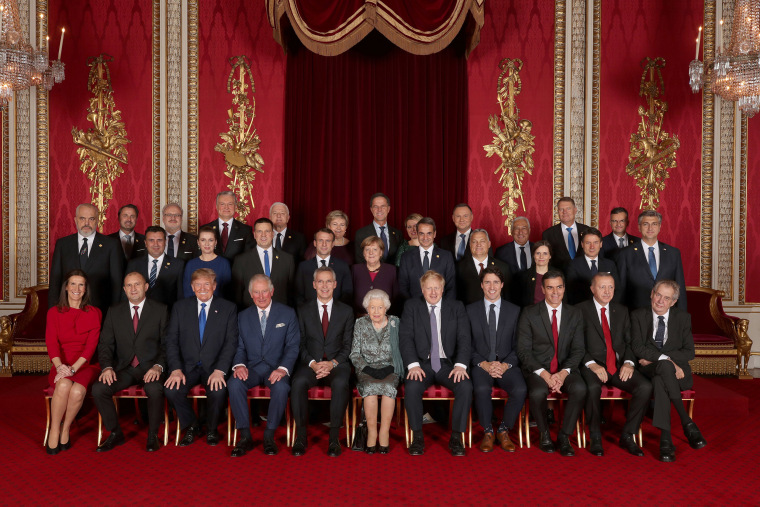 Image: Leaders of NATO alliance countries, and its secretary general, join Britain's Queen Elizabeth and the Prince of Wales for a group picture during a reception at Buckingham Palace