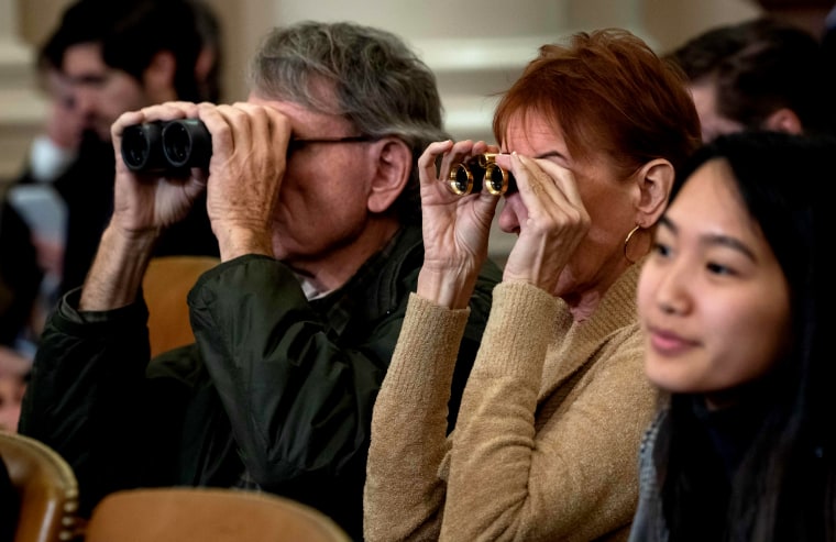 Image: Members of the public use binoculars as they watch the House Judiciary Committee hearing on the impeachment inquiry into President Donald Trump on Dec. 4, 2019.