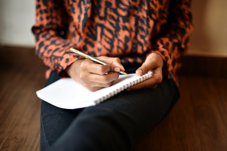 Image: Woman writing on Notepad