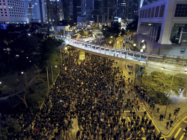 Protesters march into the night in Hong Kong on Dec. 8, 2019.