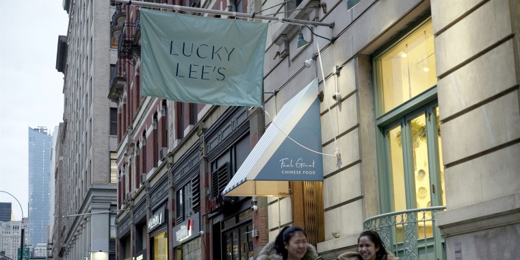 Pedestrians walk past the Lucky Lee's restaurant in the Greenwich Village neighborhood of New York on April 11, 2019.