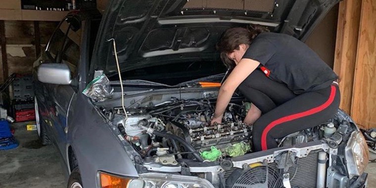 Marissa Olivares intently working on a car