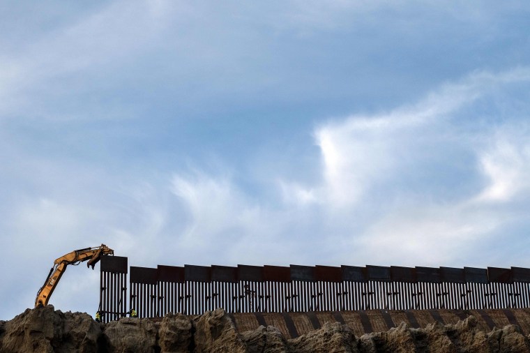 Image: Workers replace an old section of the U.S.-Mexico border fence as seen from Tijuana, Mexico, on Jan. 8, 2019.