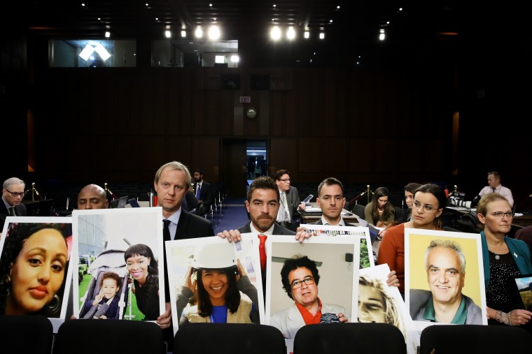 Image: BFamily members of victims of the Ethiopian Airlines crash sit with photos of their loved ones during testimony from Boeing CEO Dennis Muilenburg in Washington on Oct. 29, 2019.