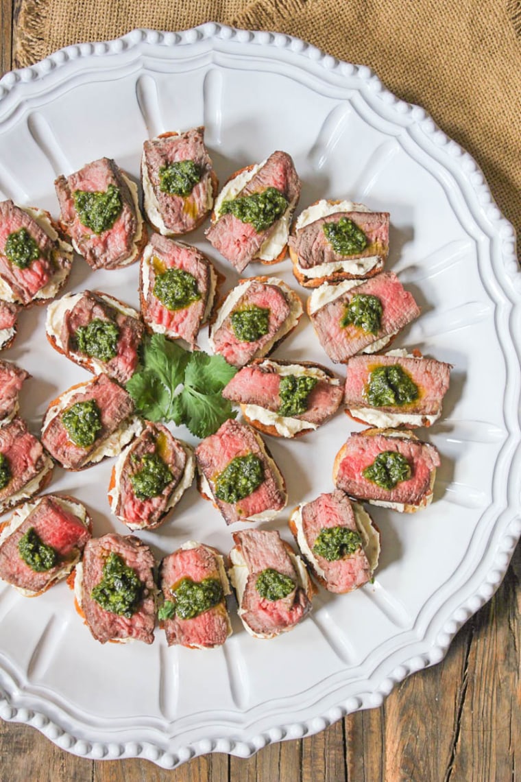 Beef tenderloin crostini with whipped goat cheese and pesto