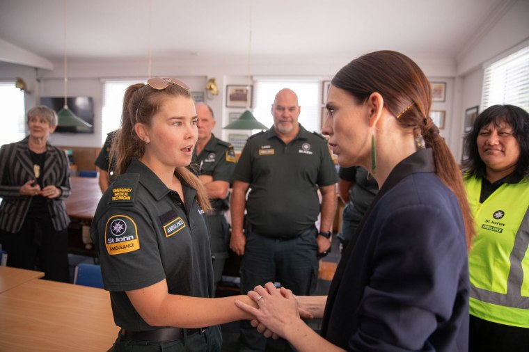 Image: New Zealand's Prime Minister Jacinda Ardern meets with a first responder that helped those injured in the White Island volcano eruption.