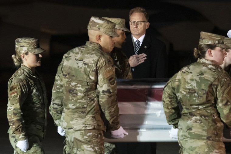 Image: Acting Navy Secretary Thomas Modly looks on as an Air Force carry team moves the transfer case containing the remains of Navy Seaman Apprentice Cameron Scott Walters