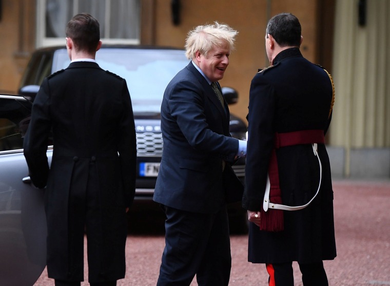 Image: Prime Minister Boris Johnson is greeted by the Queen's Equerry-in-Waiting as he arrives at Buckingham Palace for an audience with Queen Elizabeth II 