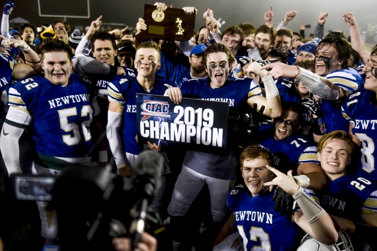 Image: The Newtown Nighthawks celebrate after winning the state football championship in Trumbull, Conn., on the seventh anniversary of the Sandy Hook mass shooting, Dec. 14, 2019.