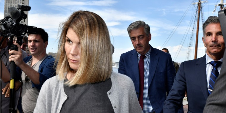 Image: Actress Lori Loughlin, and her husband, fashion designer Mossimo Giannulli leave the federal courthouse after a hearing on charges in a nationwide college admissions cheating scheme in Boston