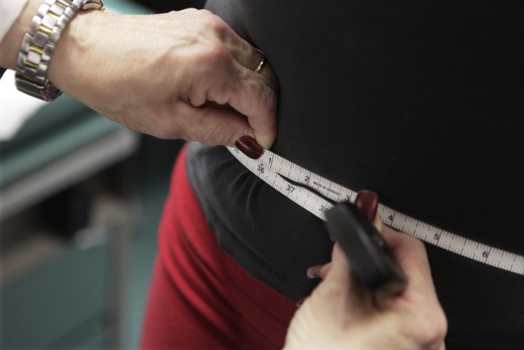 In this Jan. 20, 2010, file photo, a waist is measured during an obesity prevention study in Chicago.