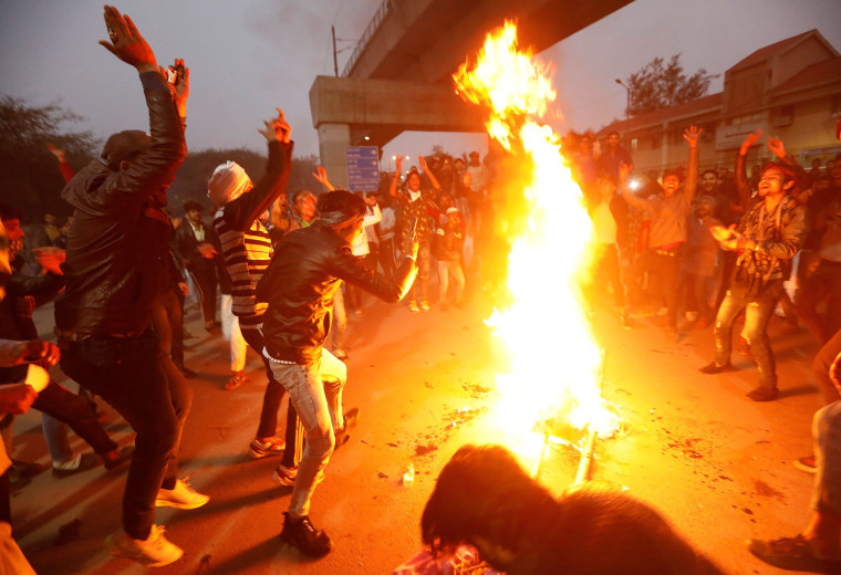 Image: Demonstrators burn an effigy depicting PM Modi during a protest against a new citizenship law, in New Delhi