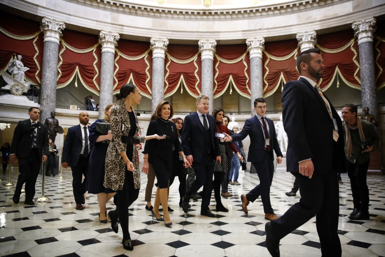 Image: House Speaker Nancy Pelosi walks to the House floor before a vote on articles of impeachment against President Donald Trump on Dec. 18, 2019.