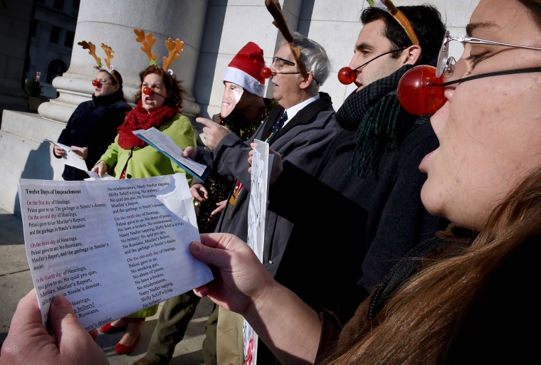 Image: Supporters of President Donald Trump sing impeachment-themed Christmas carols outside of Union Station in Washington on Dec. 18, 2019.
