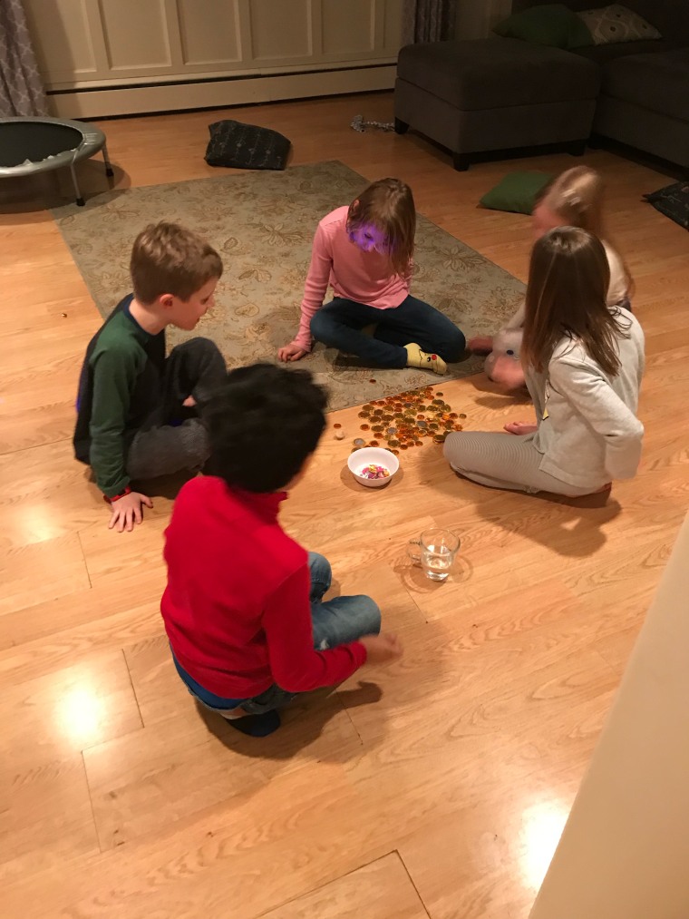 Koenig's children teach their friends the game of dreidel.
