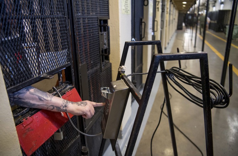 Image: An inmate uses a telephone from a cell at San Quentin State Prison in San Quentin, California.