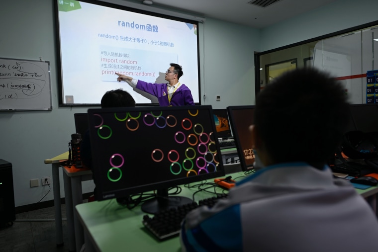 Image: A trainer leading a class at a children's computer coding training center in Beijing