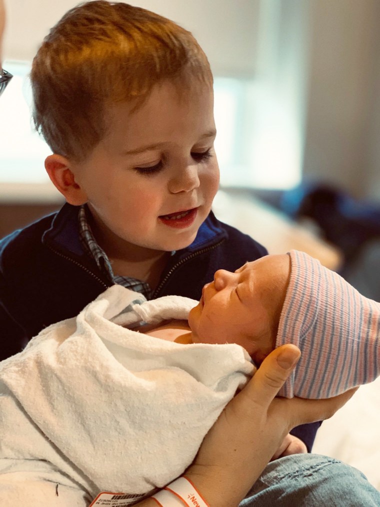 Calvin holding his baby brother, Oliver George