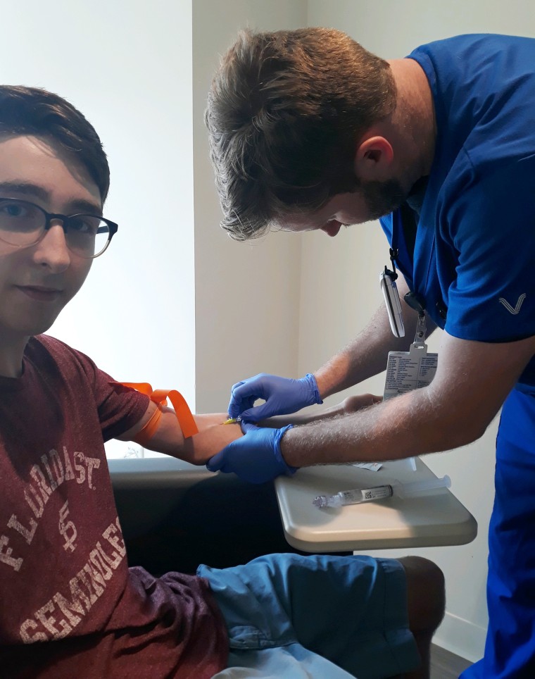 Luke, 17, was the last Desclefs diagnosed with cancer in October 2019. His brother, Blake, is a nurse at MD Anderson Cancer, and is seen here preparing Luke for his PET scan. 