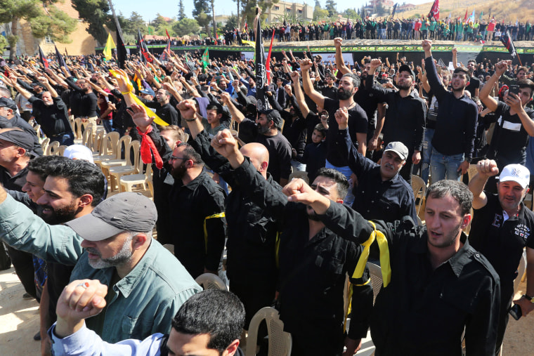 Image: Supporters of Lebanon's Hezbollah leader Sayyed Hassan Nasrallah gesture as they listen to his televised speech in Baalbeck