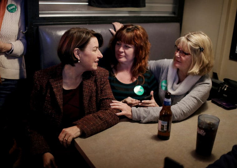 Image: Michelle and Marilyn Simpson speak with Klobuchar at a campaign stop in Algona on Dec. 27, 2019. Klobuchar just finished campaigning in all of Iowa’s 99 counties. 