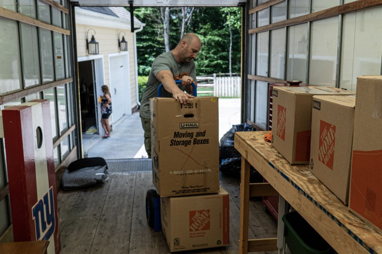 Susan Wind's husband, David, prepares the moving truck from the family's home in Mooresville for the drive to Florida.