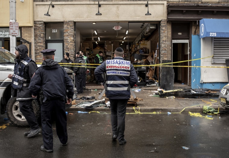 Image: Members of a Jewish Orthodox emergency response team work alongside police at the scene of a shooting at kosher supermarket in Jersey City, N.J., on Dec. 11, 2019.
