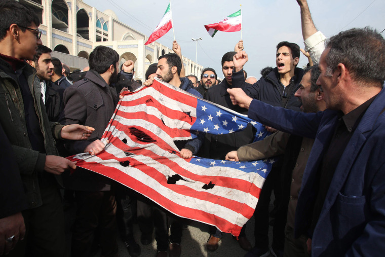 Image: Iranians tear up a U.S. flag during a demonstration in Tehran on Jan. 3, 2020 following the killing of Iranian Revolutionary Guards Major General Qassem Soleimani in a U.S. strike on his convoy at Baghdad international airport.