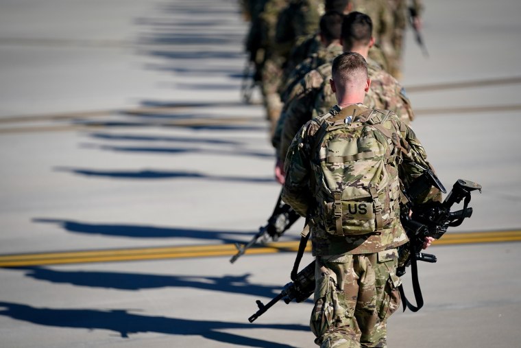 U.S. Army paratroopers assigned to the 1st Brigade Combat Team, 82nd Airborne Division, walk toward an awaiting aircraft prior to departing for the Middle East from Fort Bragg.