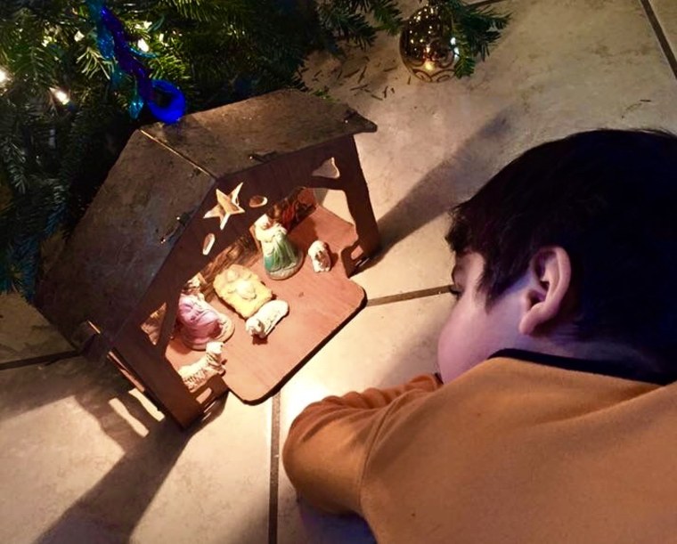 Ishel Vidal's youngest son looks at a nativity scene under his Chirstmas tree in Houston. 