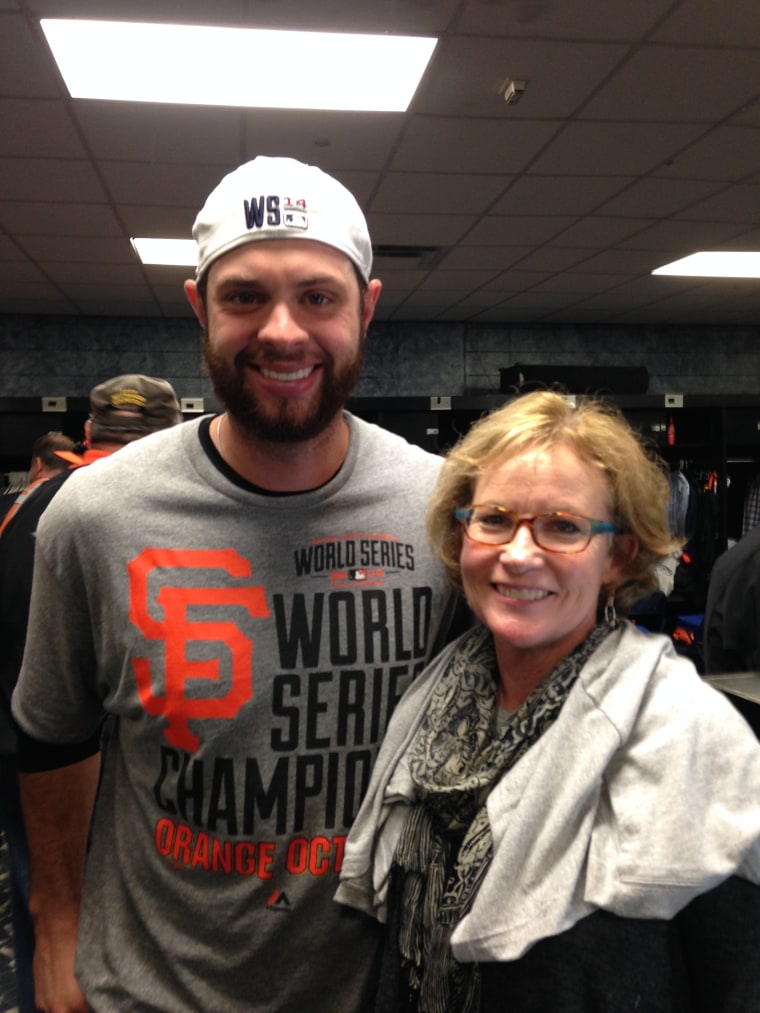 Joan Ryan and San Francisco Giants baseball player Brandon Belt at the World Series clubhouse in 2014.