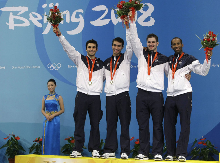 Image: Jason Rogers, from left,James Williams, Tim Morehouse and Keeth Smart of the United States celebrate with their silver medals