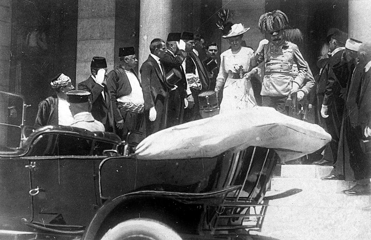 Archduke of Austria Franz Ferdinand walks to a car with his wife, Sophie, minutes before his assassination in Sarajevo on June 28, 1914.