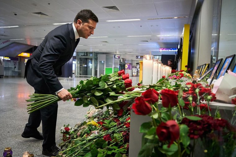 Image: Ukraine's President Volodymyr Zelensky placing flowers at a memorial for the victims of the Ukraine International Airlines Boeing 737-800 crash in the Iranian capital Tehran, at the Boryspil airport outside Kiev