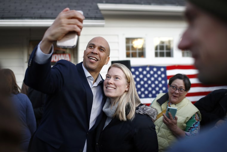 Image: Democratic presidential candidate Sen. Cory Booker, D-N.J., poses for a selfie with an attendee after speaking at a campaign event at the home of Polk County Democratic Chair Sean Bagniewski, Tuesday, Jan. 7, 2020, in Des Moines, Iowa.