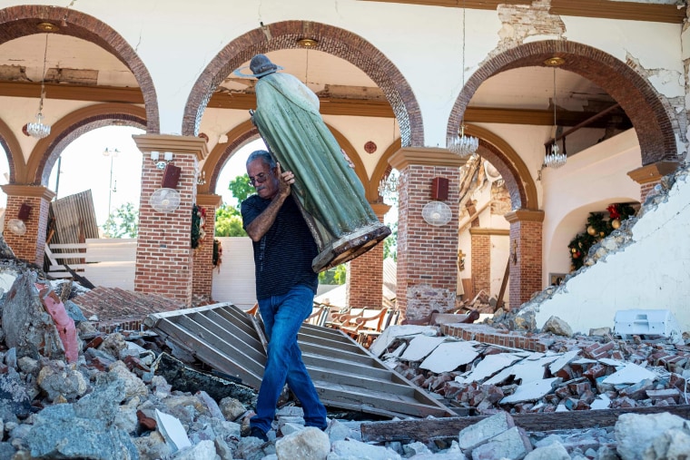 A man carries a St. Jude statue from the Inmaculada Concepcion church that collapsed after an earthquake hit the island in Guayanilla, Puerto Rico on Jan. 7, 2020.
