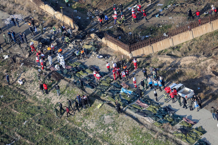 Image: People and rescue teams amid bodies and debris after a Ukrainian plane carrying 176 passengers crashed near Imam Khomeini airport in the Iranian capital Tehran