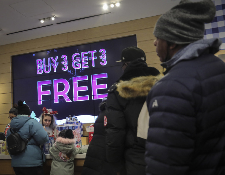Image: Shoppers stand in line at Bath and Bodyworks in the Brooklyn borough of New York.
