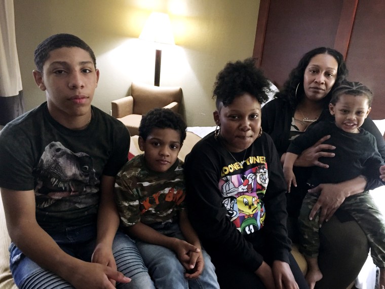 Sequena Pettiford with her four children at a hotel in Durham, where they were evacuated after carbon monoxide leaks were discovered at McDougald Terrace.