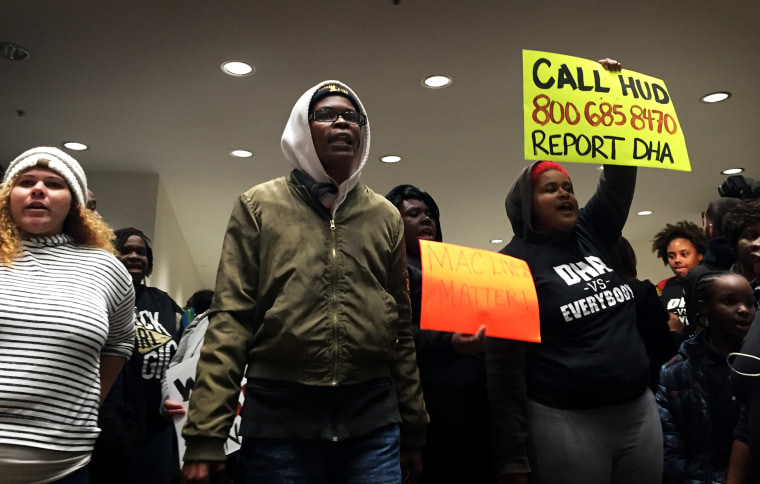 Ashley Canady, president of the McDougald Terrace resident council, and her neighbors rally outside Monday's City Council meeting in Durham