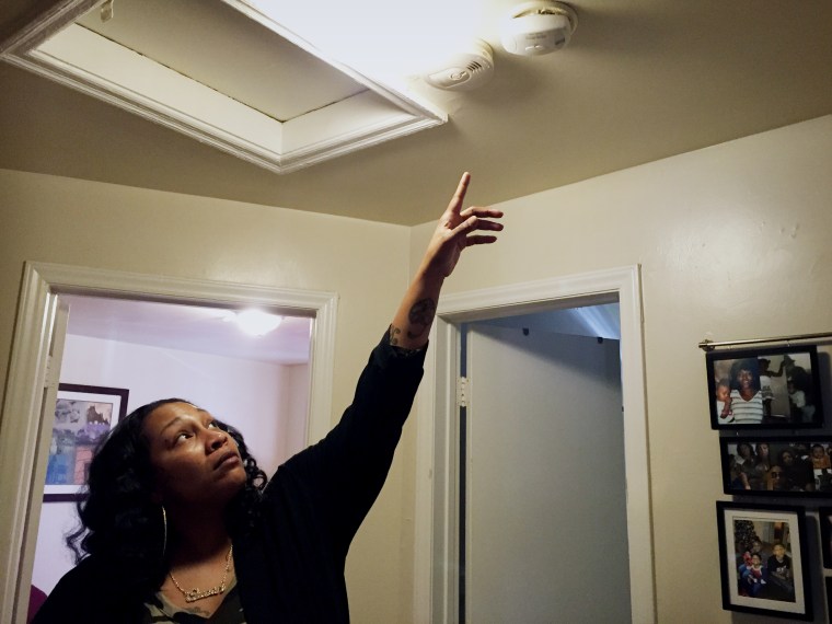 Image: Sequena Pettiford points to a new carbon monoxide detector that was installed in her McDougald Terrace apartment.