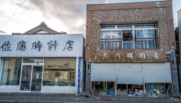 Image: Futaba's clock shop, left, and butcher shop in the still uninhabitable town.