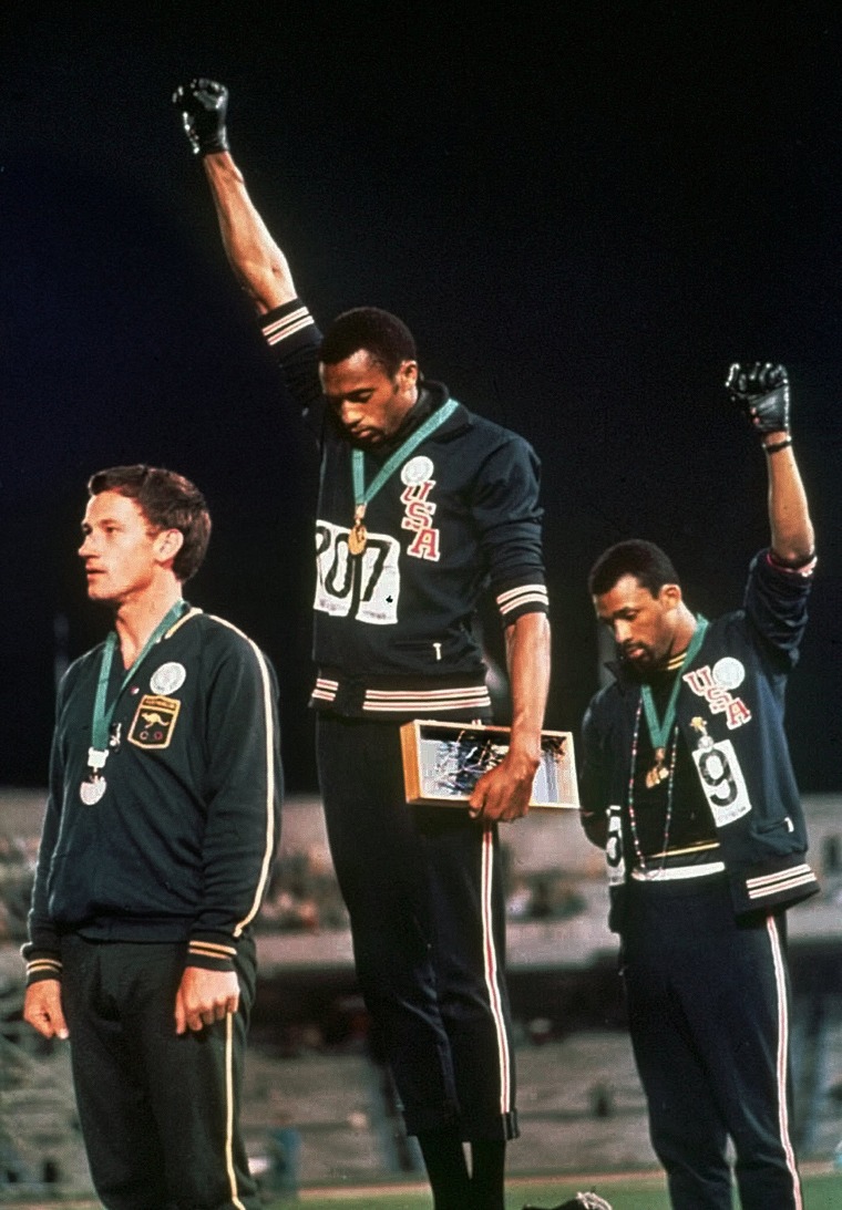 Image: U.S. athletes Tommie Smith, center, and John Carlos Extending  protest during the "The Star-Spangled Banner"