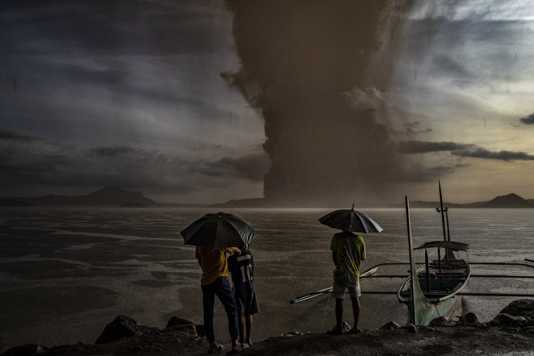 Image: Residents look on as Taal Volcano erupts on Jan. 12, 2020 in Talisay, Batangas province, Philippines.