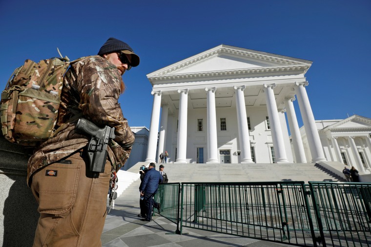 Image: Gun rights activist with handgun outside the Capitol building in Richmond, Virginia